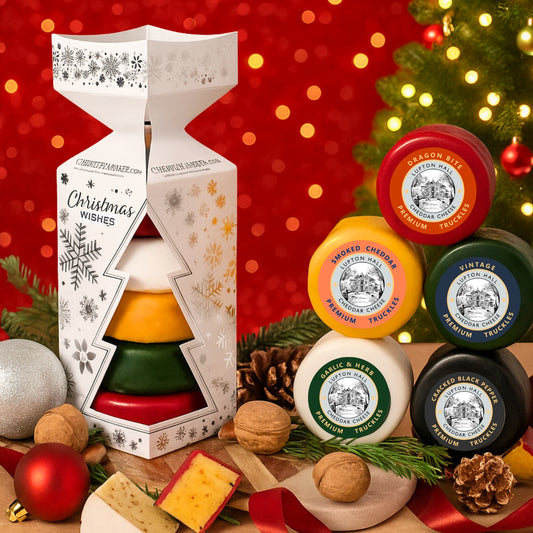 Cheese Christmas Cracker decorative packaging on a festive background with Christmas tree and lights.