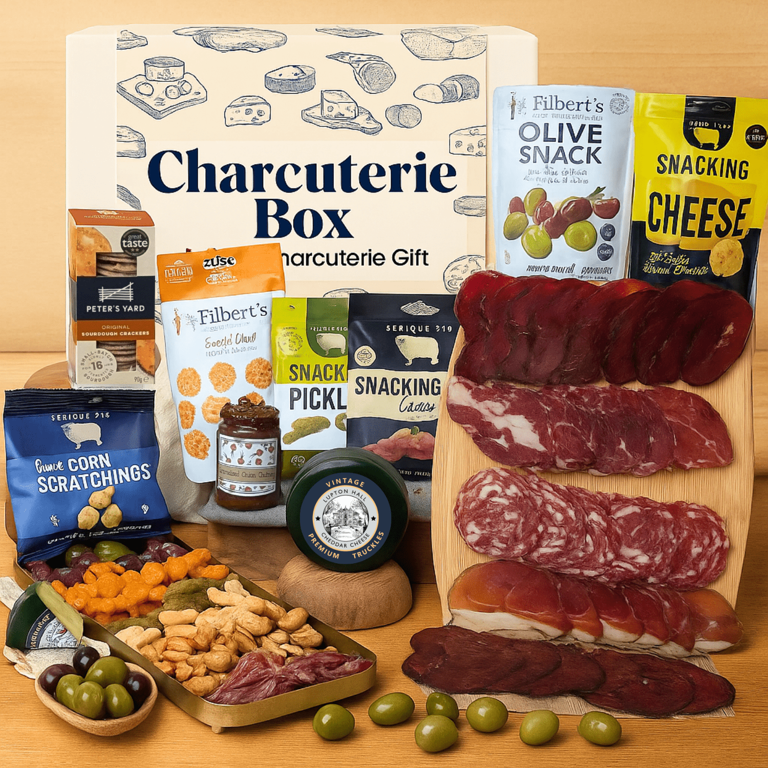 Charcuterie box with meats, cheeses, and snacks on a wooden board surface