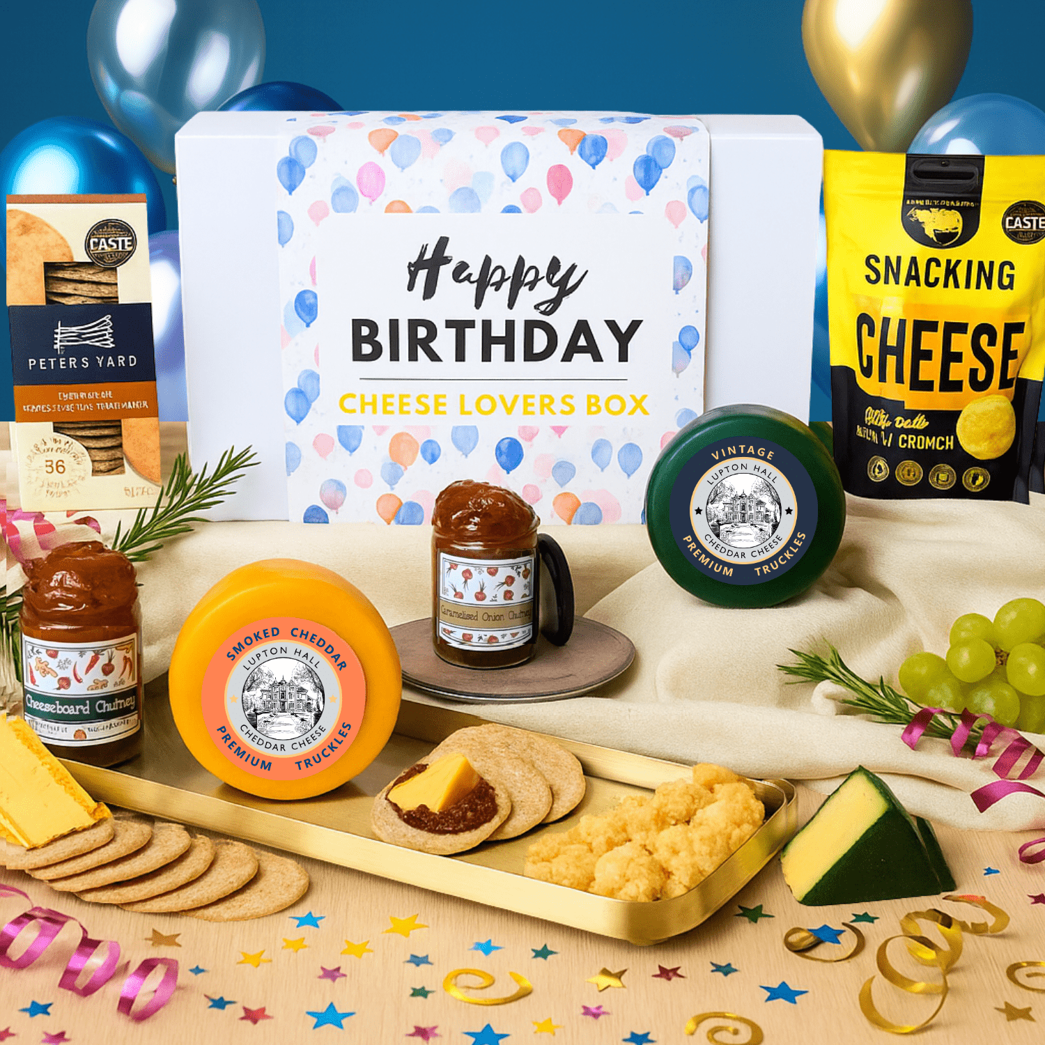 Birthday cheese gifts lovers box with various cheeses, crackers, and accompaniments on a festive background.