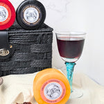 Lifestyle image of the cheese and wine hamper on a rustic wooden table, perfect for dinner parties and gatherings
