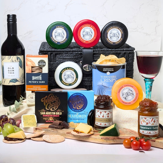 Luxury Cheese & Wine Hamper featuring 12 gourmet items, including artisan cheeses, chutneys, indulgent chocolates, and Old Gum Tree Shiraz (75cl), beautifully packaged for gifting